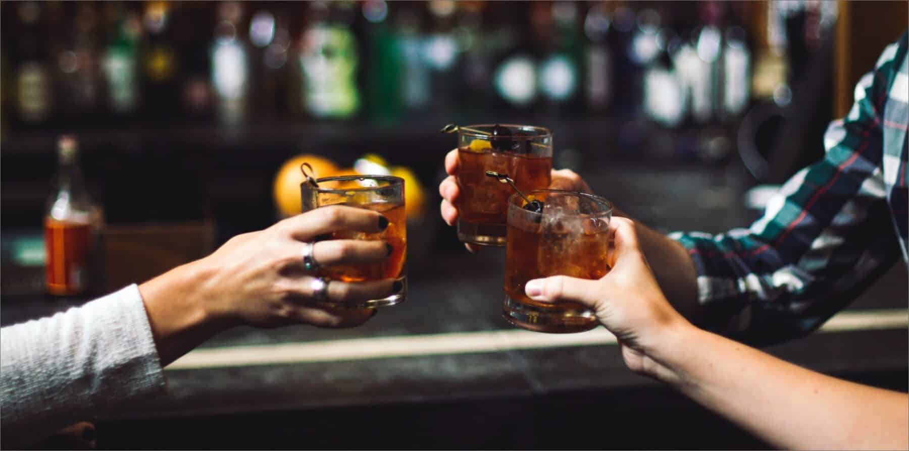 3 friends enjoying drinks at the bar