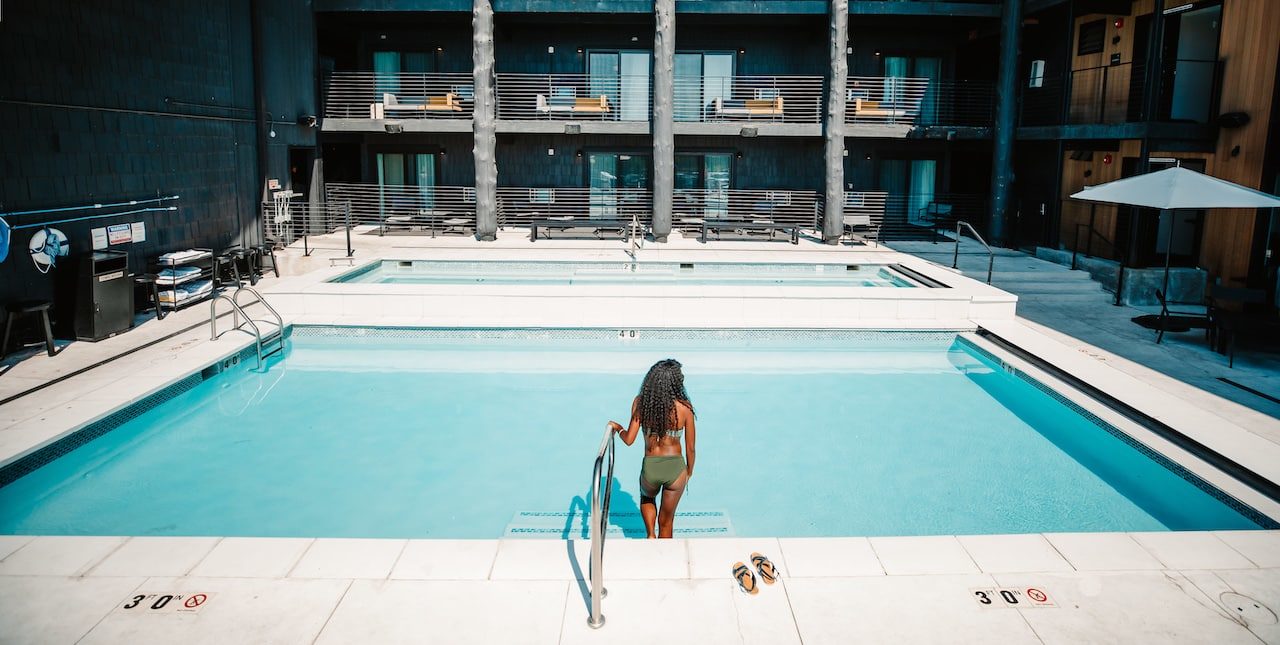 Woman walking into pool