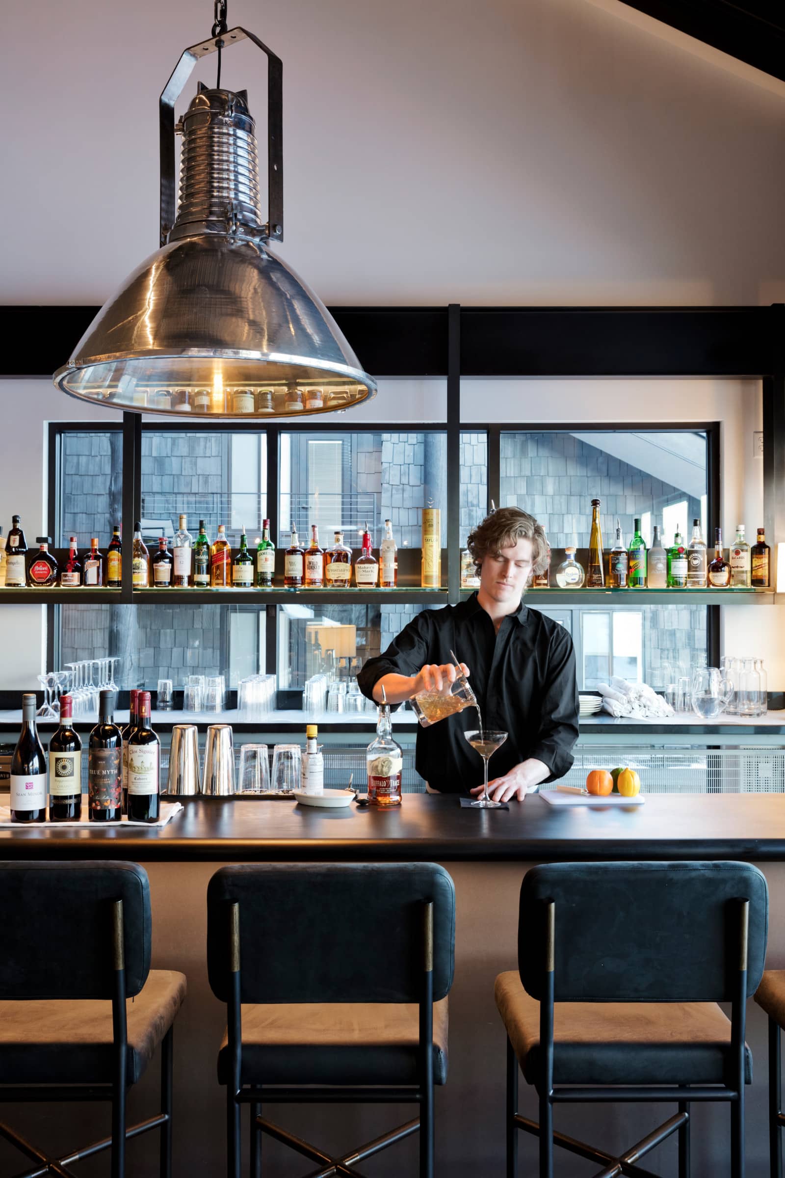 Continuum bartender pouring drink